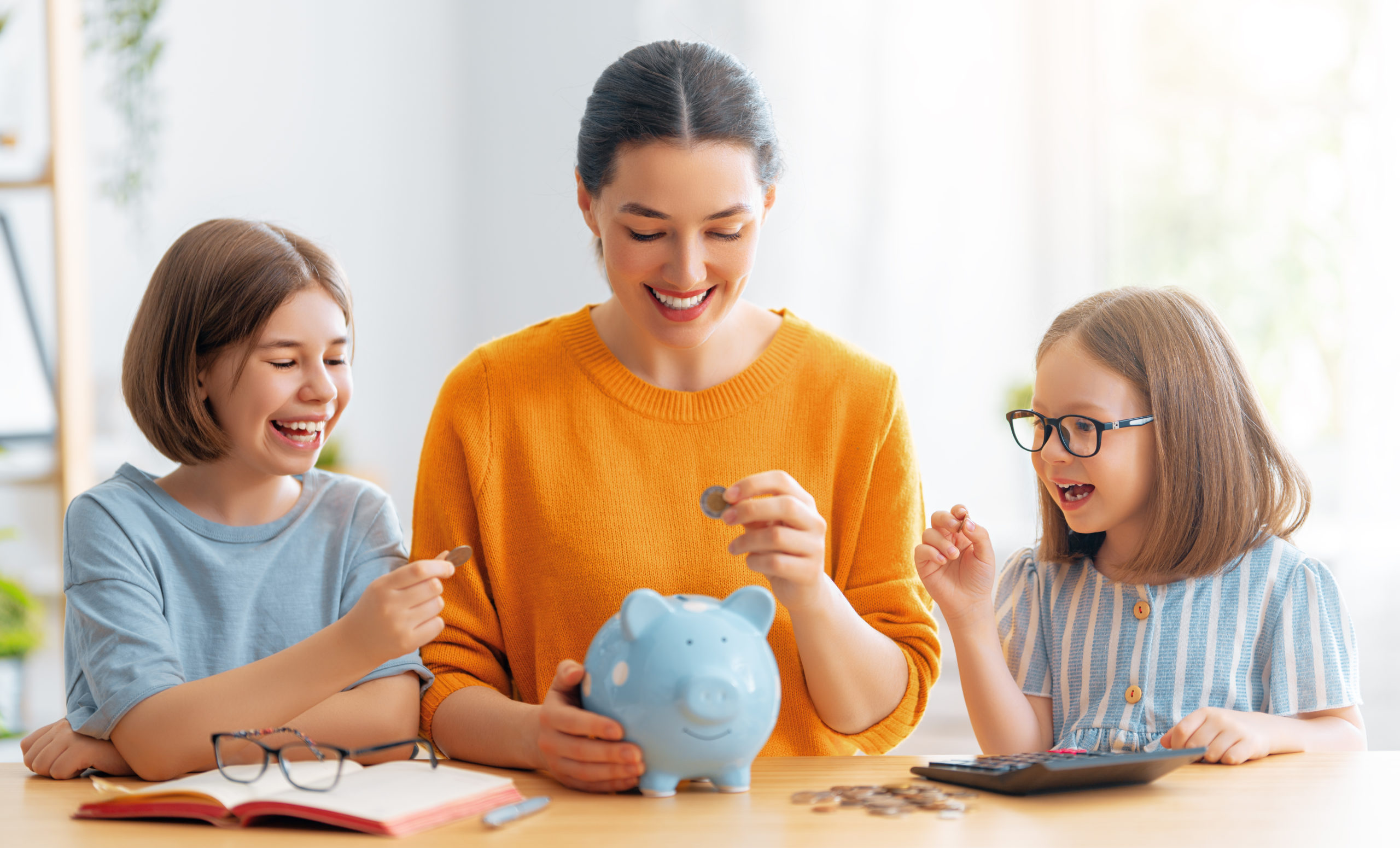 mom and kids saving money in piggy bank